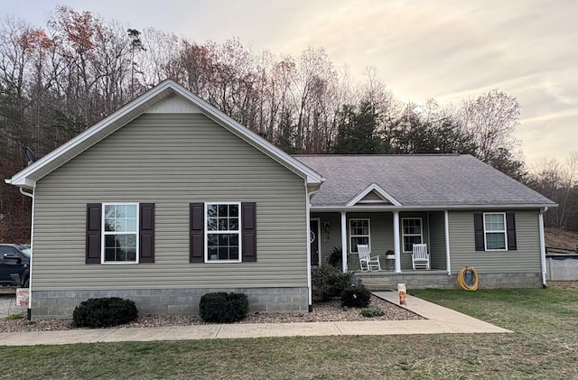 view of front of house with a lawn and covered porch