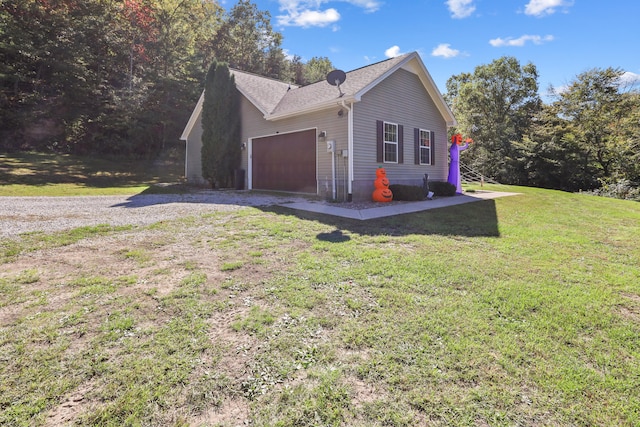 view of property exterior with a lawn and a garage