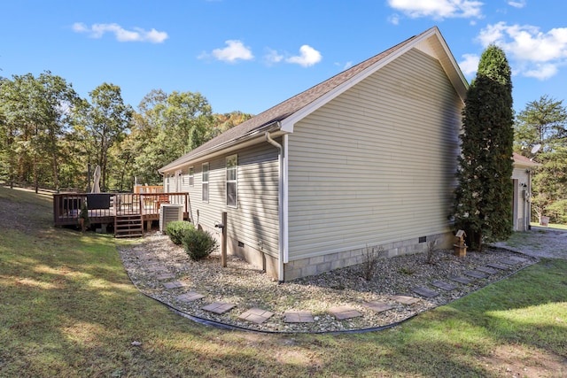 view of home's exterior featuring a lawn and a wooden deck