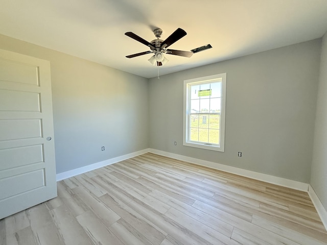 unfurnished room with ceiling fan and light wood-type flooring