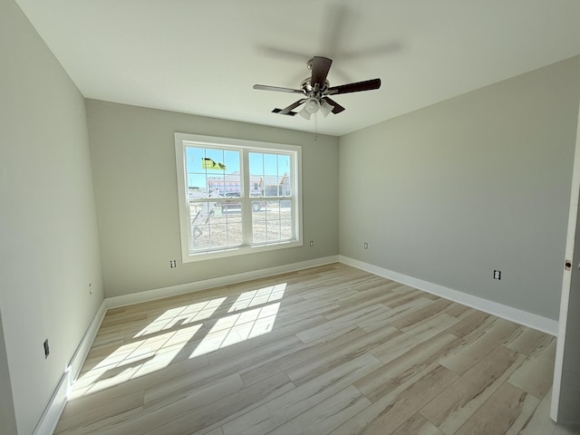 unfurnished room with ceiling fan and light hardwood / wood-style flooring