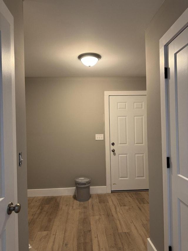 interior space with baseboards and wood finished floors