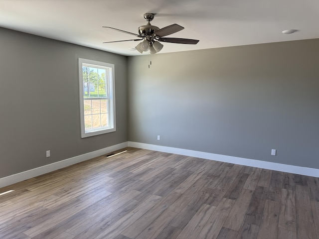 218 Little Acres Rd, Lily, KY 40740 - empty room with ceiling fan, baseboards, dark wood finished floors, and visible vents
