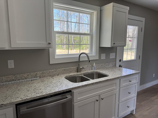 218 Little Acres Rd, Lily, KY 40740 - kitchen featuring stainless steel dishwasher, white cabinetry, wood finished floors, a healthy amount of sunlight, and a sink