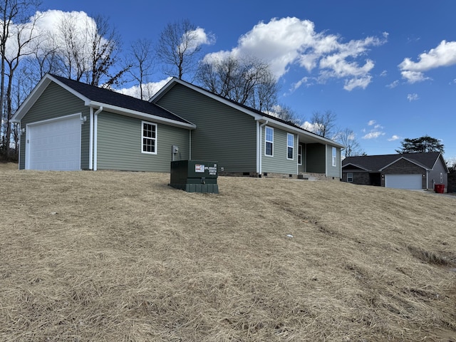 view of side of property featuring an attached garage