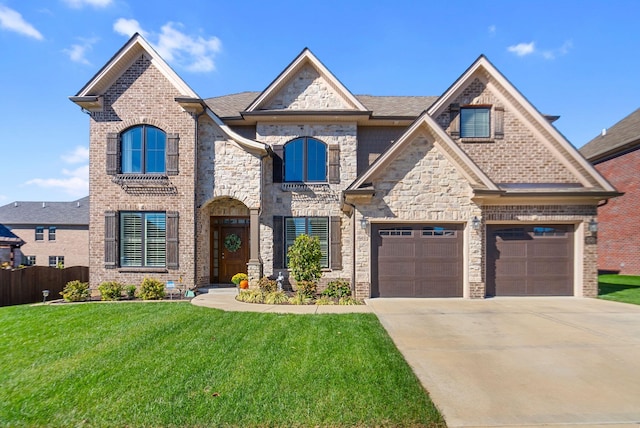 view of front of property featuring a front yard and a garage