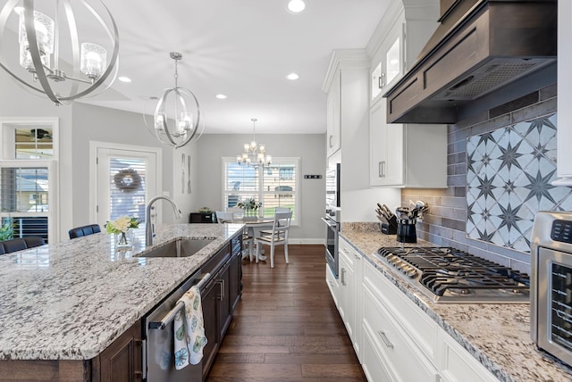 kitchen featuring exhaust hood, sink, decorative backsplash, and white cabinetry