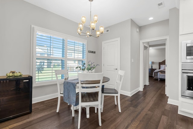 dining space with a chandelier and dark hardwood / wood-style flooring