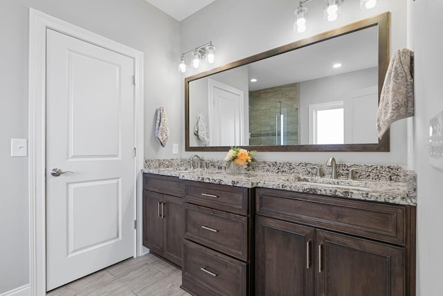 bathroom featuring an enclosed shower, hardwood / wood-style floors, and vanity