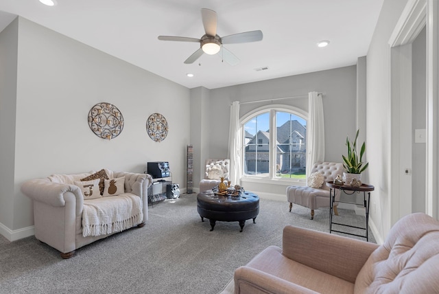 living room featuring carpet flooring and ceiling fan