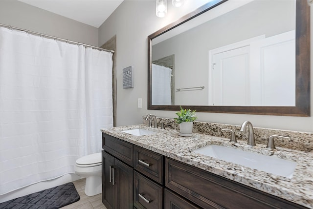 bathroom with walk in shower, vanity, and toilet