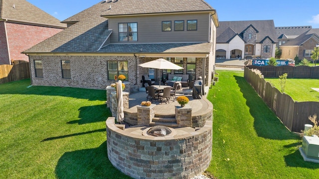 rear view of property featuring a patio and a lawn