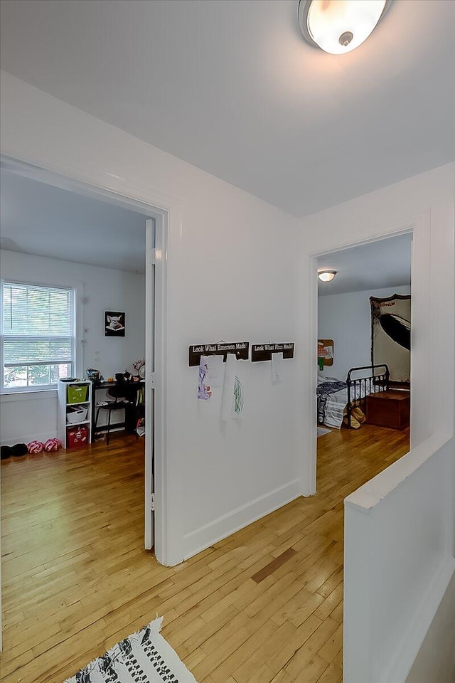 hallway with hardwood / wood-style flooring