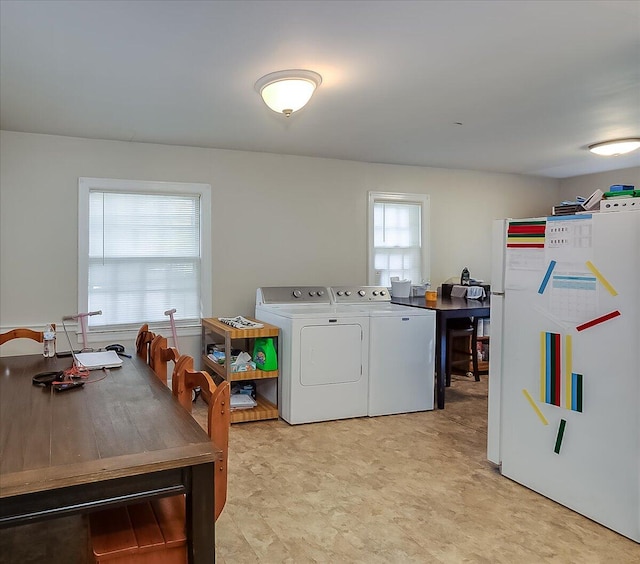 clothes washing area featuring washing machine and clothes dryer and a healthy amount of sunlight