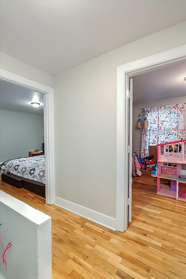 hall with hardwood / wood-style floors