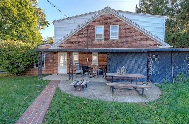 rear view of house featuring a yard and a patio area