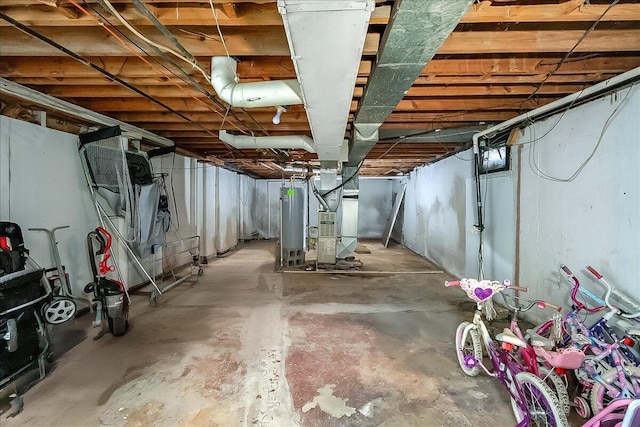 basement featuring gas water heater and heating unit