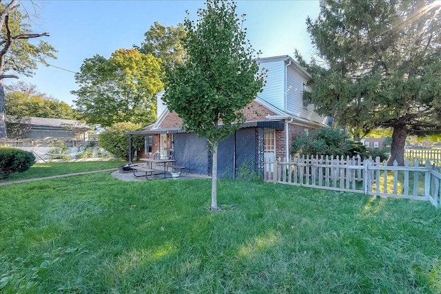 exterior space featuring a front lawn and a patio