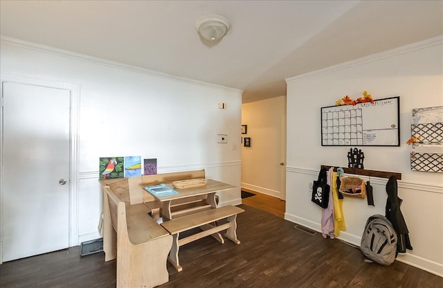 dining space featuring dark hardwood / wood-style floors and ornamental molding