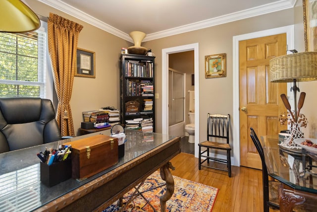 office area featuring light wood-style floors and ornamental molding