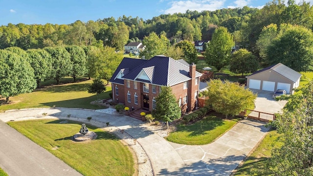 birds eye view of property with a wooded view