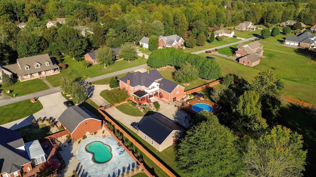 aerial view with a wooded view and a residential view