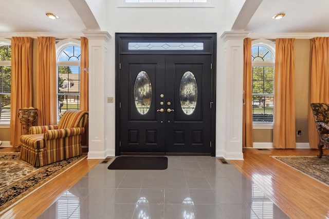 foyer with ornate columns and hardwood / wood-style flooring