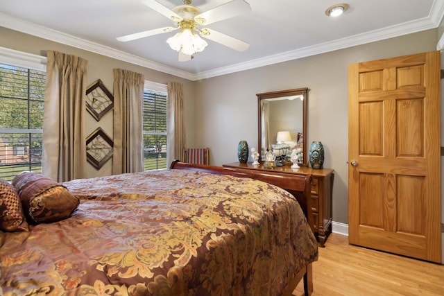 bedroom featuring light wood-style flooring, multiple windows, and crown molding