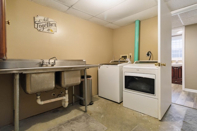 laundry room with independent washer and dryer, laundry area, and a sink