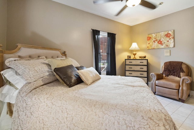 bedroom with ceiling fan and tile patterned flooring