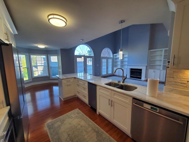 kitchen with decorative light fixtures, sink, dark hardwood / wood-style floors, white cabinets, and appliances with stainless steel finishes