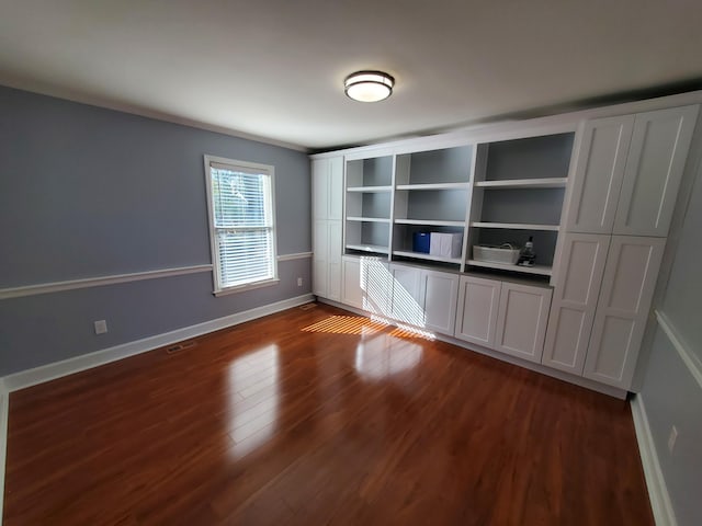 spare room featuring dark wood-type flooring