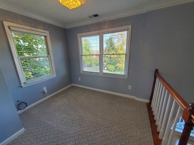 carpeted empty room featuring crown molding