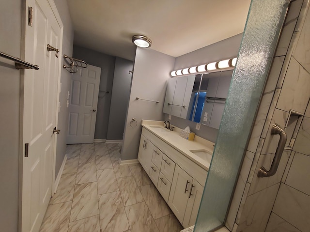 bathroom featuring a shower with door and vanity