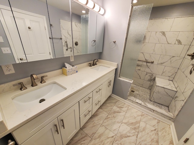 bathroom with a tile shower and vanity