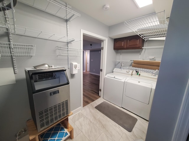 laundry room featuring independent washer and dryer and light hardwood / wood-style floors