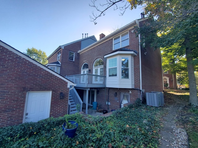 back of house featuring a deck and central air condition unit