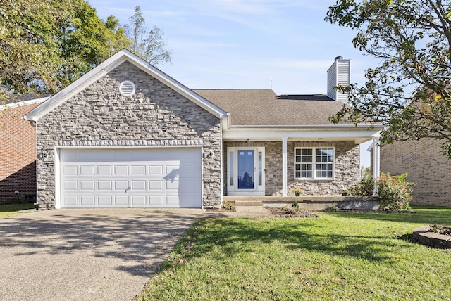 view of front of property with a front yard and a garage