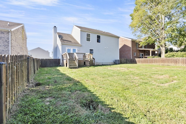 rear view of house with a yard, a deck, and central air condition unit