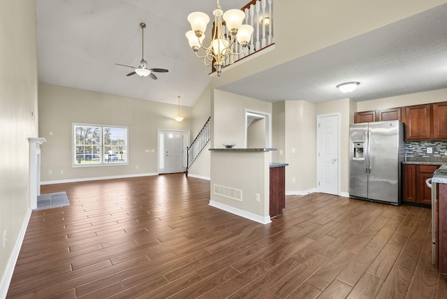 kitchen with stainless steel refrigerator with ice dispenser, ceiling fan with notable chandelier, backsplash, and dark hardwood / wood-style floors