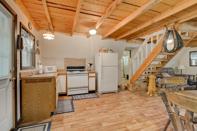 kitchen featuring a healthy amount of sunlight, white appliances, wooden ceiling, and light hardwood / wood-style flooring