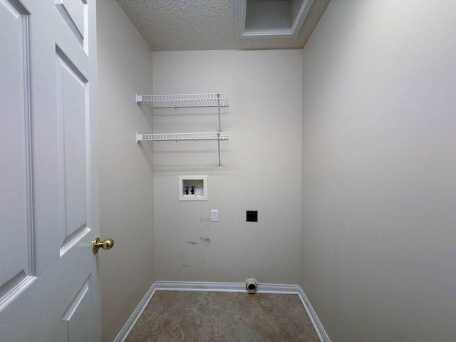 clothes washing area featuring laundry area, hookup for a washing machine, baseboards, and electric dryer hookup