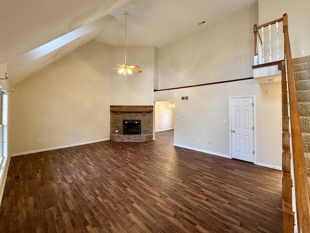 unfurnished living room featuring high vaulted ceiling, dark wood-type flooring, a fireplace, visible vents, and baseboards