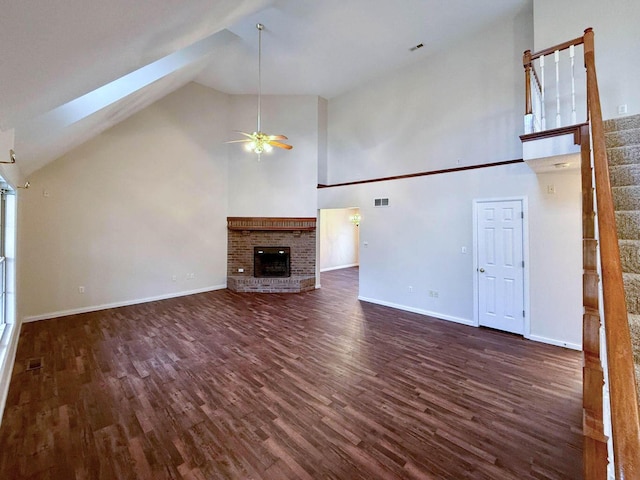 unfurnished living room featuring visible vents, a brick fireplace, high vaulted ceiling, and dark wood-style flooring