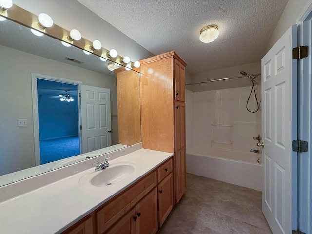 bathroom featuring vanity, bathtub / shower combination, visible vents, and a textured ceiling