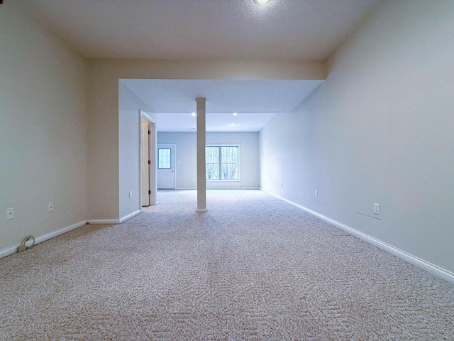 empty room with baseboards and carpet