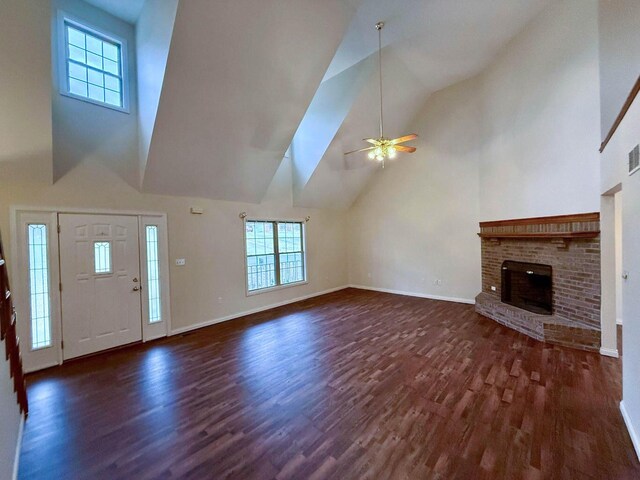 unfurnished living room featuring a brick fireplace, dark wood-type flooring, high vaulted ceiling, and ceiling fan