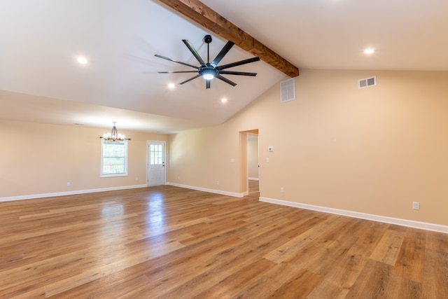 unfurnished room with ceiling fan with notable chandelier, vaulted ceiling with beams, and light hardwood / wood-style flooring