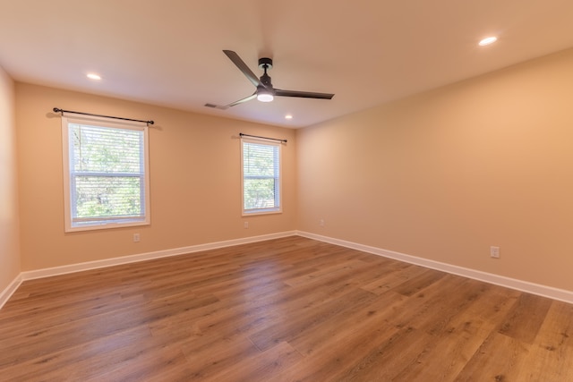 empty room with ceiling fan and hardwood / wood-style floors