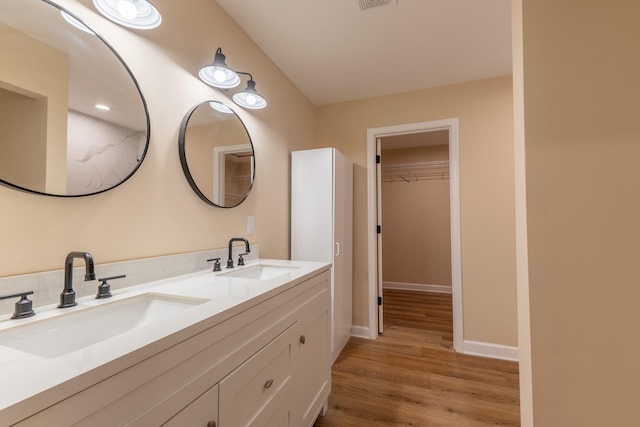 bathroom with vanity and hardwood / wood-style floors